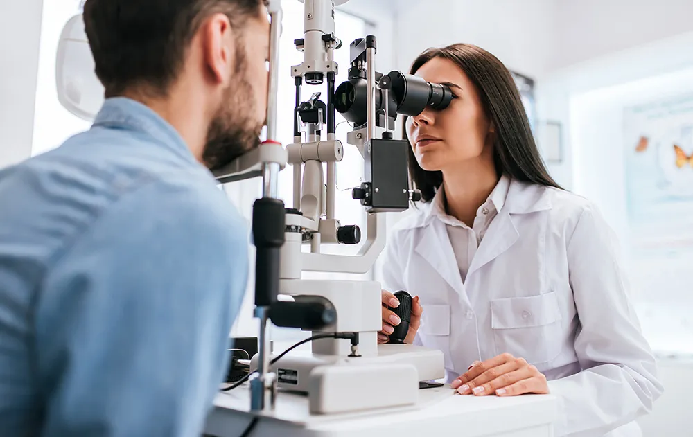 Optometrist checking a patient's vision at a slit lamp
