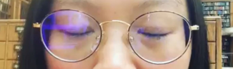 Dr Carina demonstrating blue filter glasses